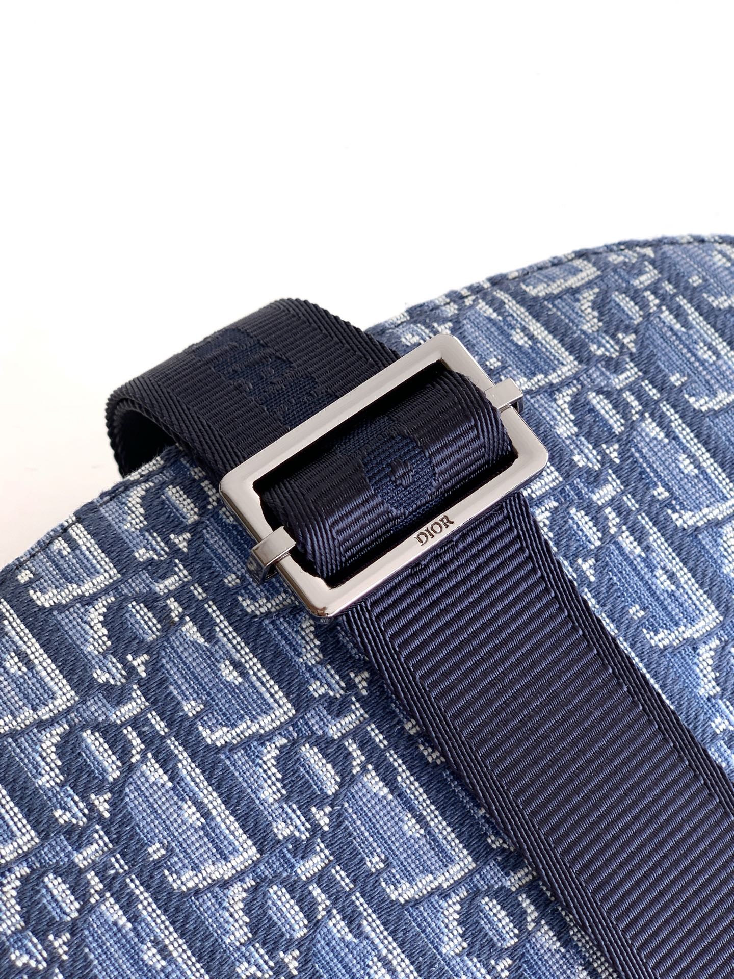 Dior strap buckle detail on blue monogram flap bag