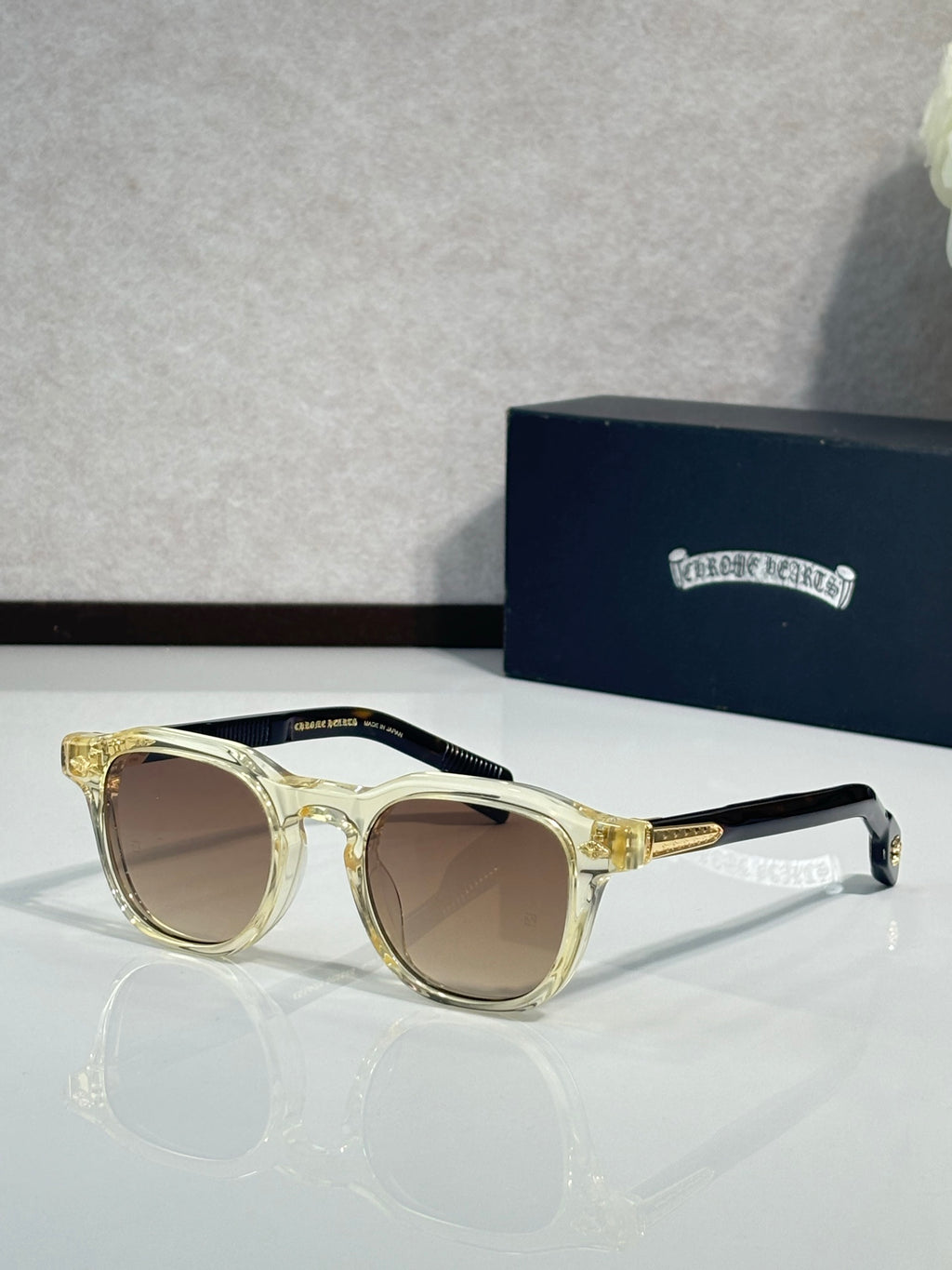Gold-tone round sunglasses with brown lenses and sleek temple arms