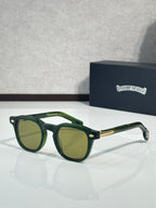 Green round sunglasses with green lenses and gold-tone temple accents