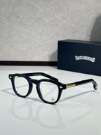 Black round eyeglasses with clear lenses and gold-tone temple accents
