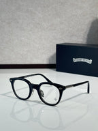 Black round eyeglass frames with clear lenses and metal side arms