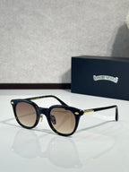 Black round eyeglass frames with tinted lenses and gold-tone temples