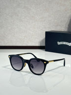 Black round eyeglass frames with dark lenses and gold-tone temples