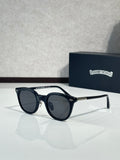 Black round eyeglass frames with dark lenses and gold-tone temples
