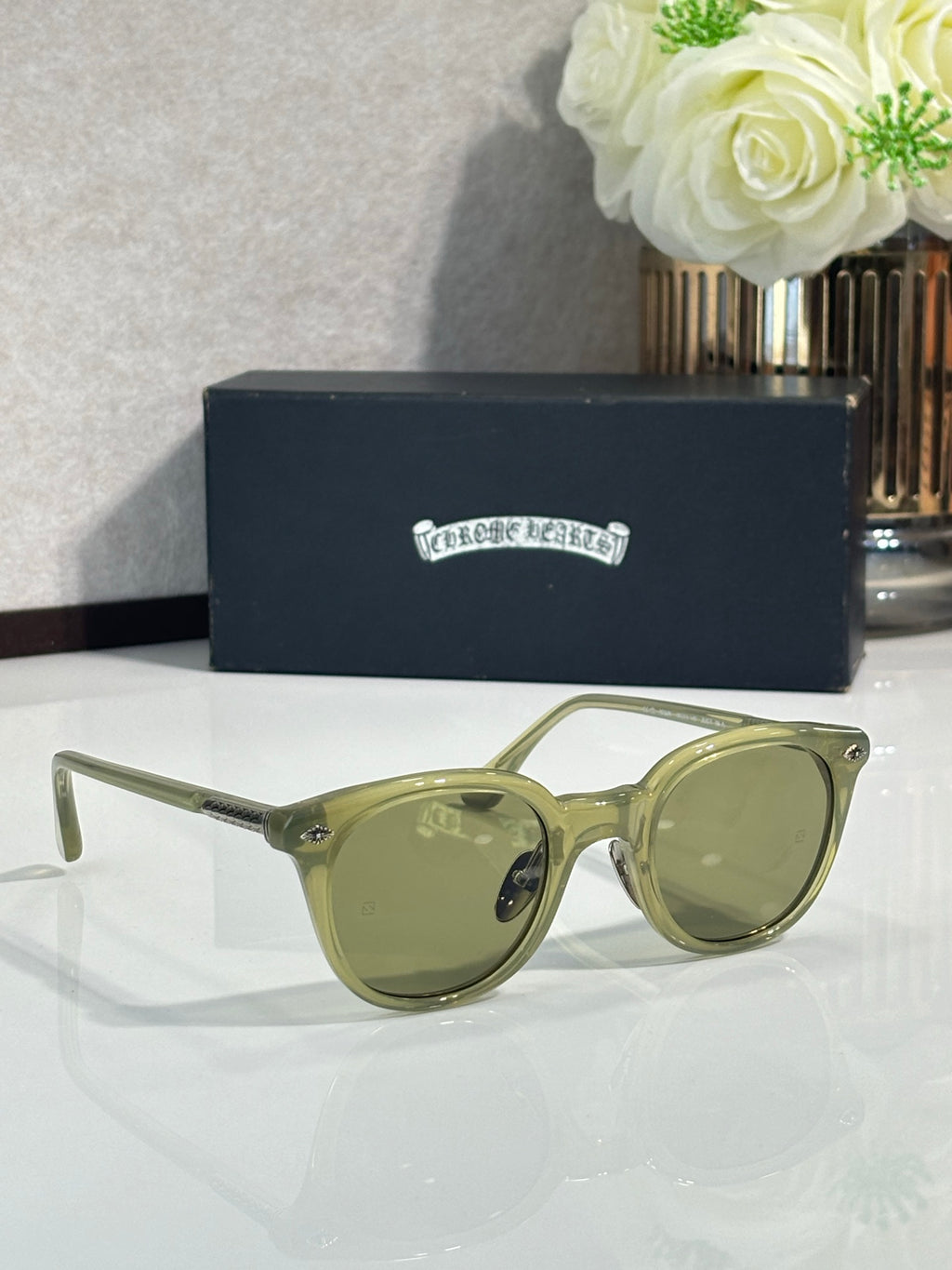 Olive green cat-eye eyeglasses with tinted lenses and gold-tone details