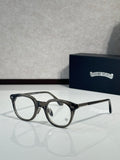 Black round eyeglasses with clear lenses and thin gold details