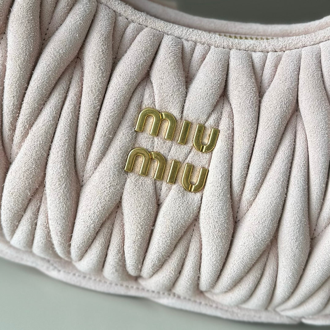 Light pink matelasse handbag with embroidered gold-tone “miu miu” logo