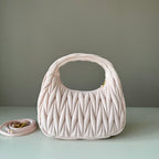 Light pink matelasse mini handbag with gold-tone logo and side view