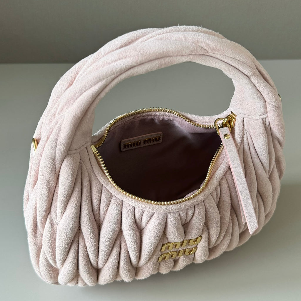 Light pink matelasse mini handbag with open interior and gold zipper