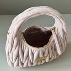 Light pink matelasse mini handbag with open interior and gold zipper