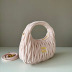 Light pink matelasse mini handbag with gold-tone hardware and strap loop