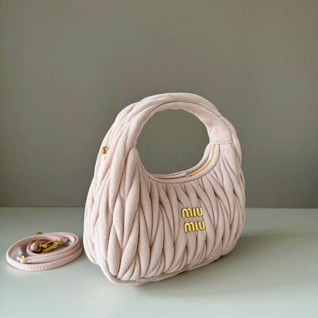 Light pink matelasse mini handbag with gold-tone hardware and strap loop