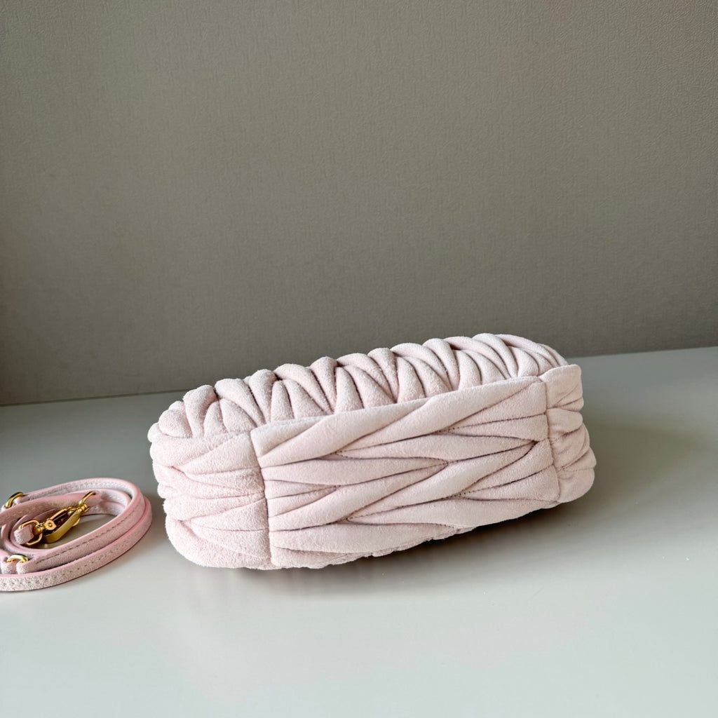 Light pink matelasse clutch-style handbag with braided top flap detail
