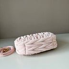 Light pink matelasse clutch-style handbag with braided top flap detail