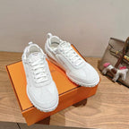 White Hermes unisex lace-up sneakers, pair view, textured side stripes, logo tongue