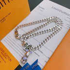 Louis Vuitton silver chain necklace with gold clasp and multicolor charm, on card