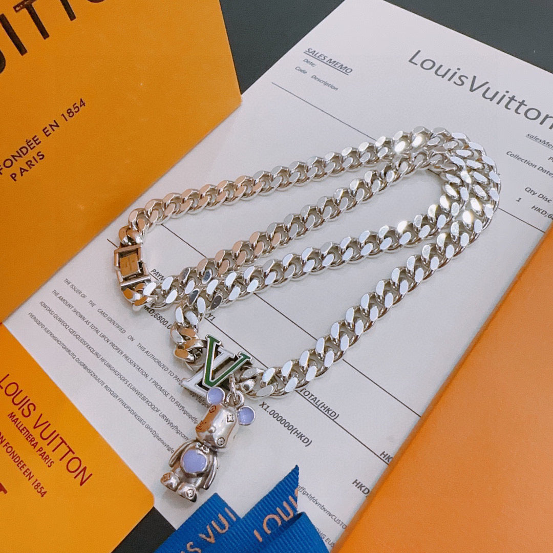 Louis Vuitton silver chain necklace with gold clasp and multicolor charm, on card