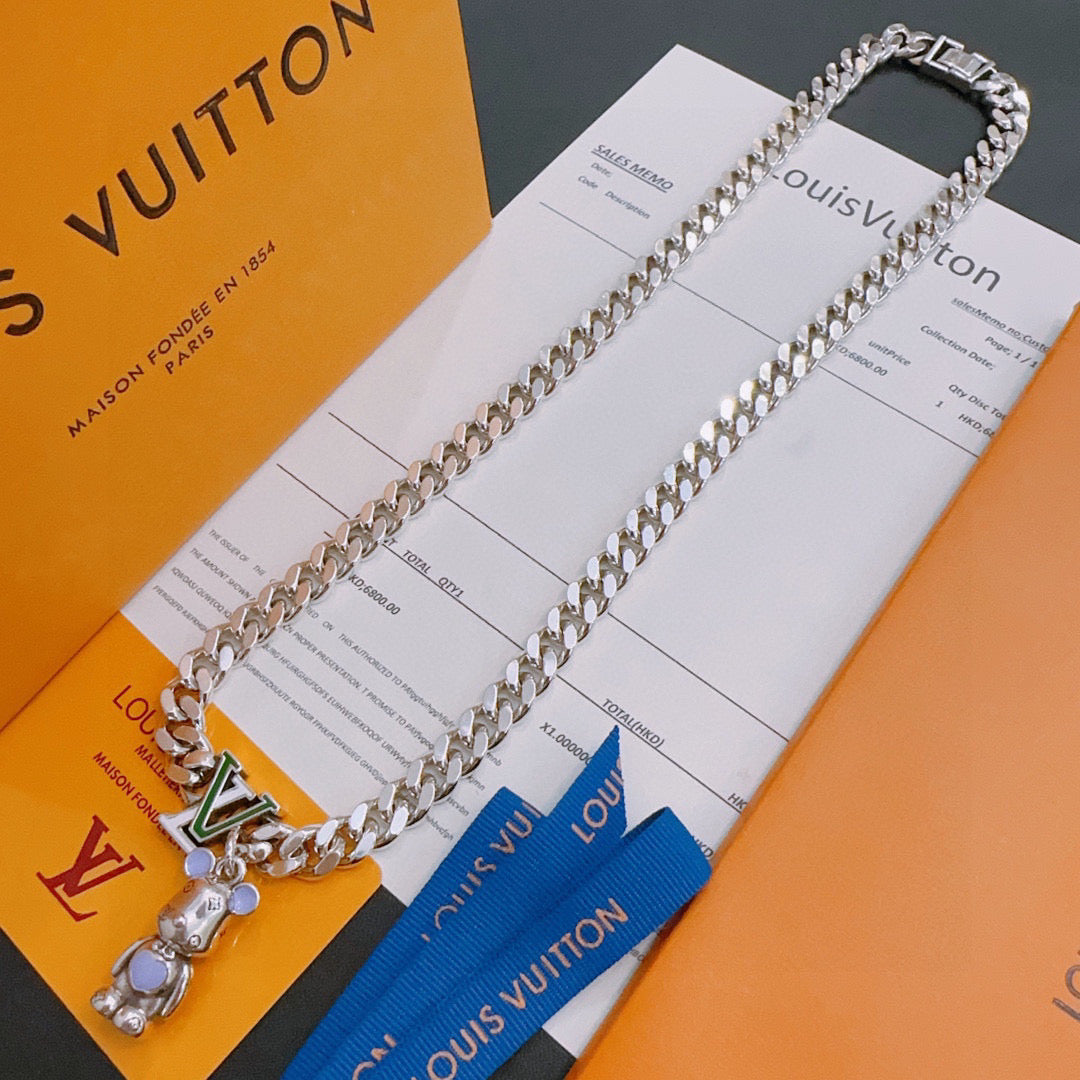 Louis Vuitton silver chain necklace with green V pendant and bear charm, on cards