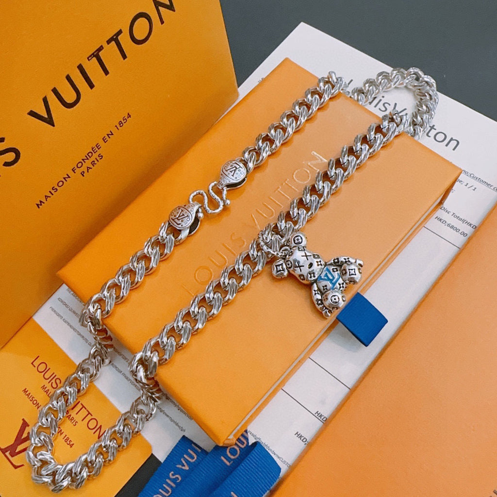Louis Vuitton silver chain necklace with charm pendant and blue tag, on box