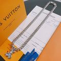 Louis Vuitton silver chain necklace with small charm pendant, flat on card