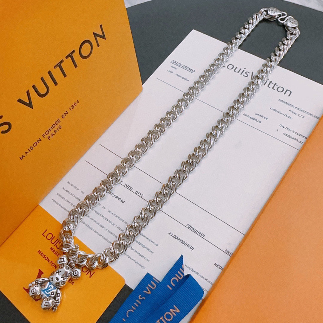 Louis Vuitton silver chain necklace with small charm pendant, flat on card