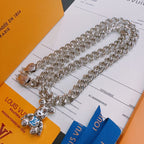 Louis Vuitton silver chain necklace with multiple charm pendants, on display