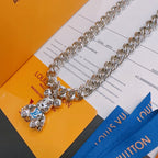 Louis Vuitton silver chain necklace with charm pendant and blue tag, flat lay
