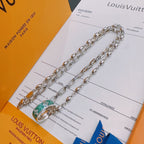 Silver-tone chain necklace with green and orange enamel pendant