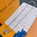 Silver-tone chain necklace with green enamel pendant centerpiece