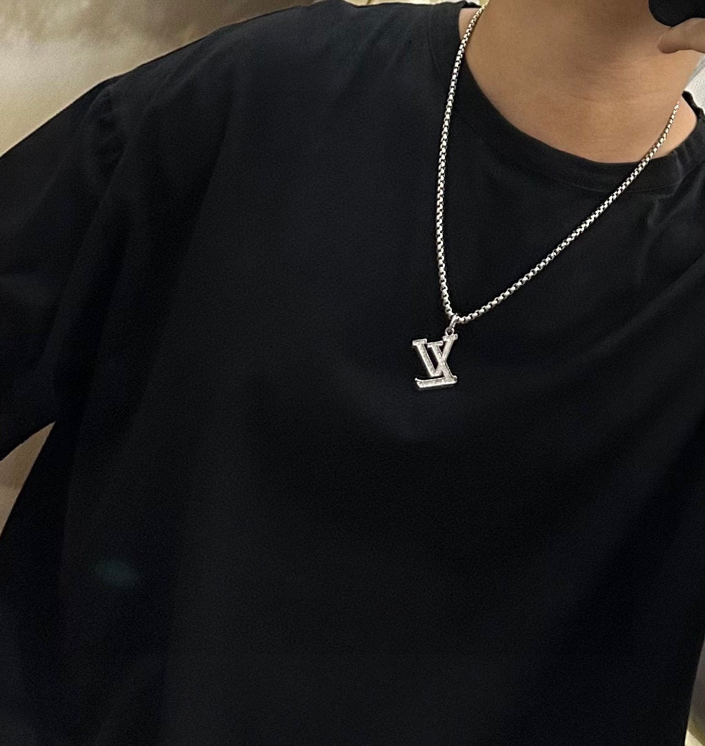 Silver-tone LV pendant necklace on a chain