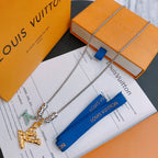 Louis Vuitton necklace with silver chain, gold pendant, and blue ribbon tag, on box