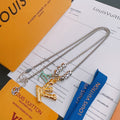 Louis Vuitton necklace with silver chain and mixed metal pendant charms, on display