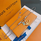 Louis Vuitton necklace with silver chain and gold crown pendant, on orange gift box