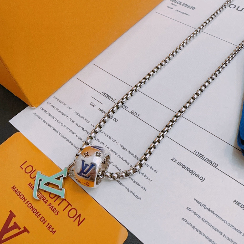 Silver-tone chain necklace with multicolor square charm pendant, close-up on cards.