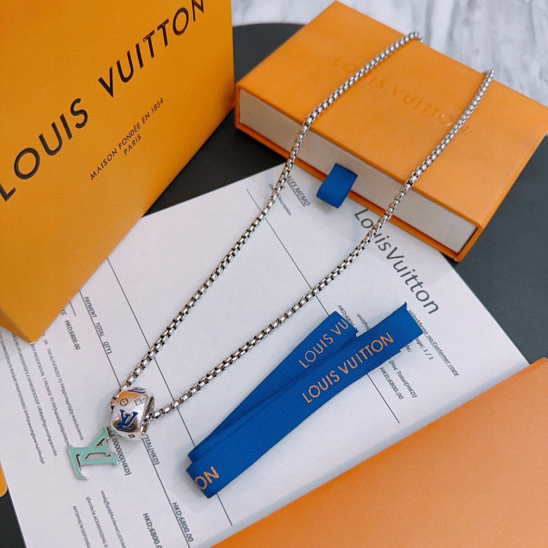 Silver-tone chain necklace with multicolor charm pendant, shown with gift box and cards.