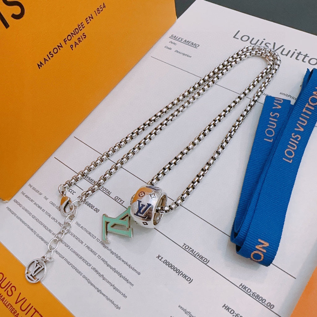 Silver-tone chain necklace set with square charm pendants and blue ribbon.