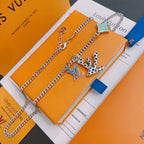Silver-tone chain necklace set with green star charm and geometric multicolor pendant
