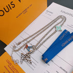 Silver-tone chain necklace with green star charm and geometric multicolor pendant