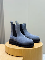 Moncler suede Chelsea boots with elastic side panels and chunky dark rubber sole, angled
