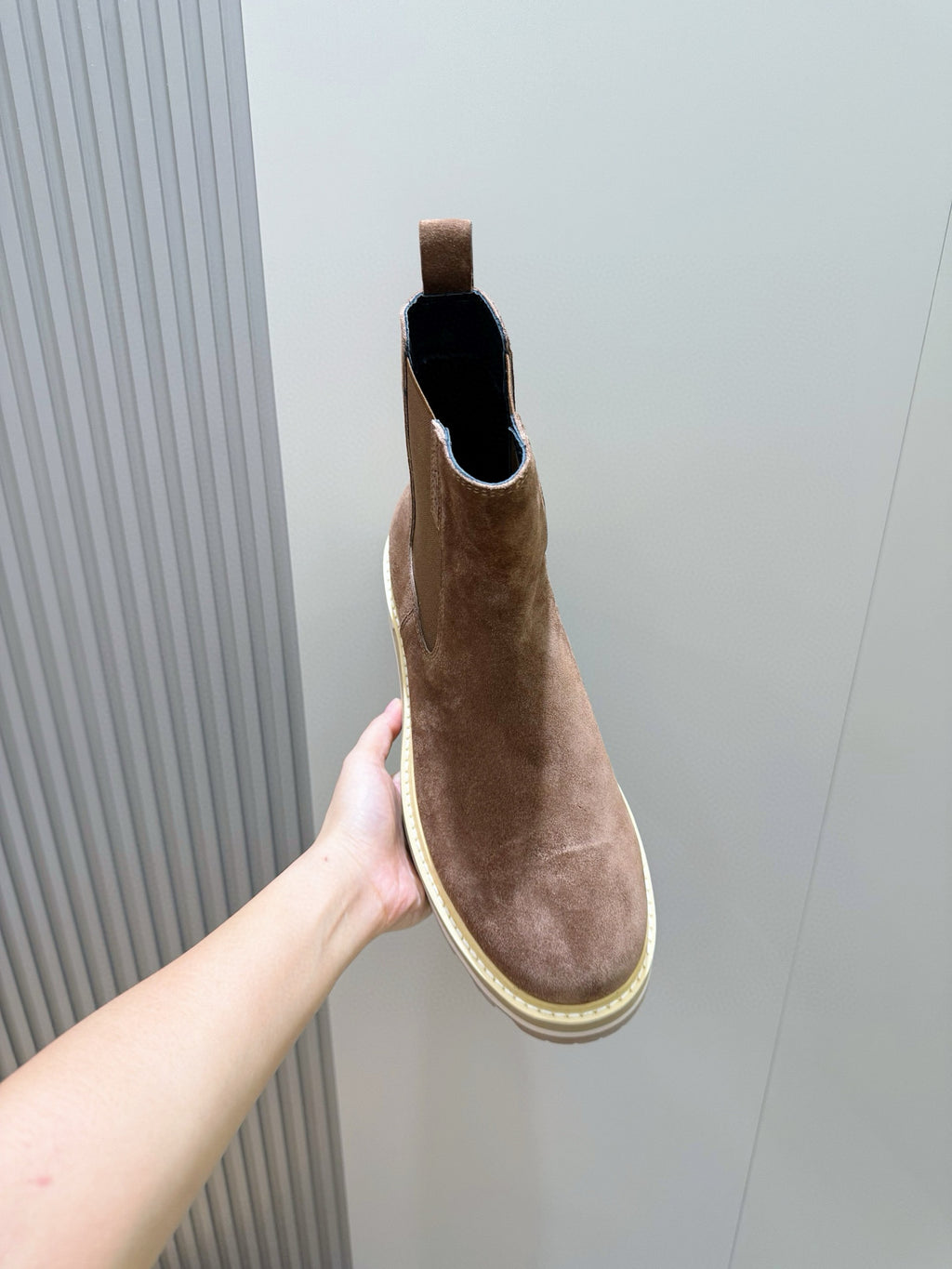 Moncler brown suede Chelsea boot held up, black-lined collar and elastic gore