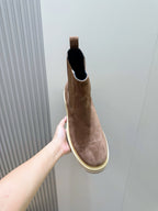Moncler brown suede Chelsea boot held up, black-lined collar and elastic gore