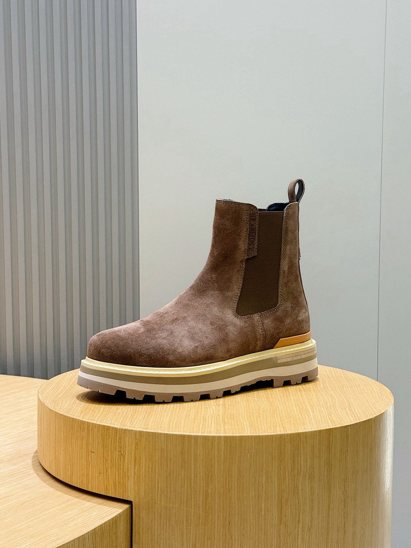 Moncler brown suede Chelsea boot on display, ankle height with elastic side panels