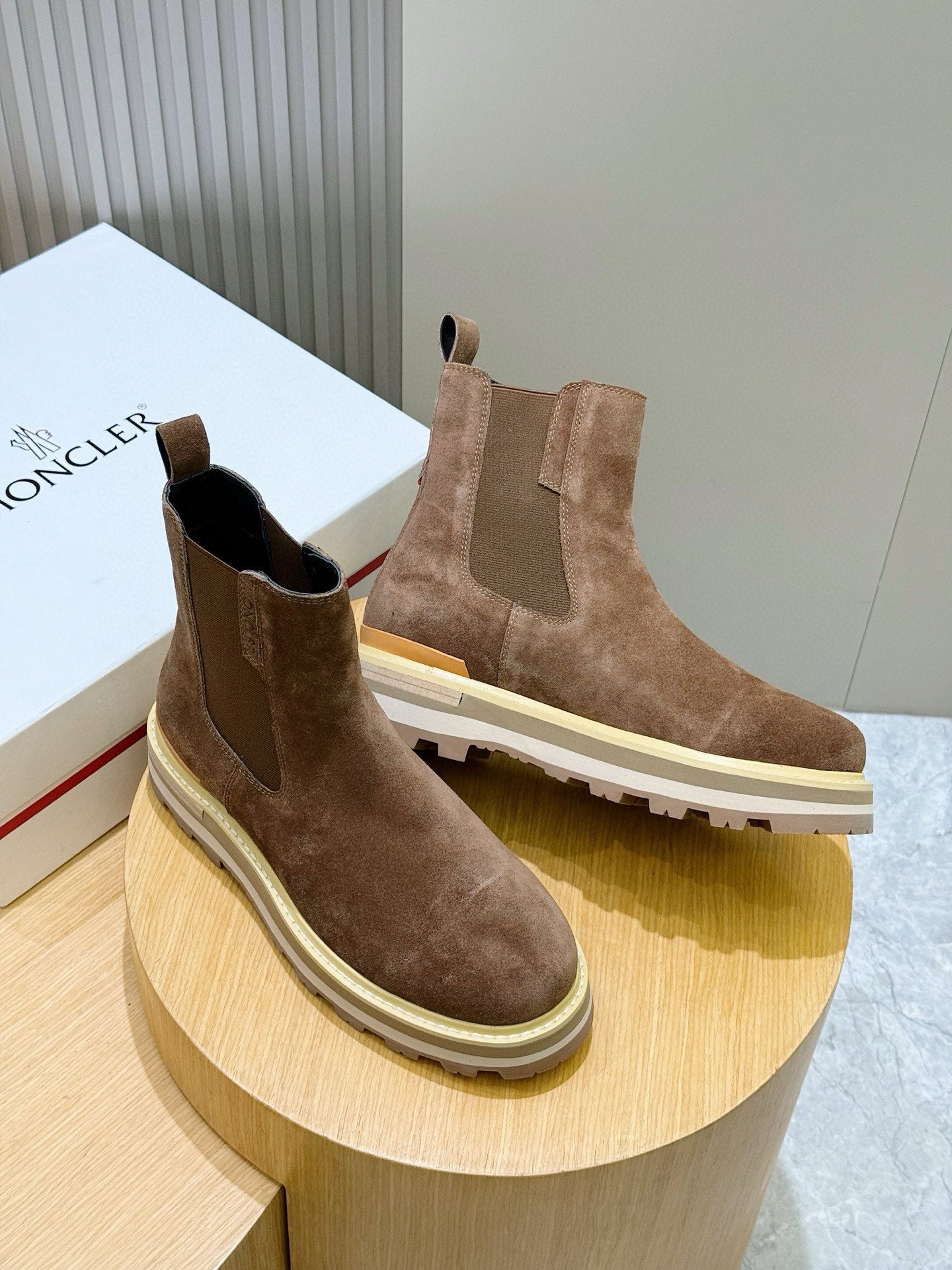 Moncler brown suede Chelsea boots on display, pair with elastic side gores