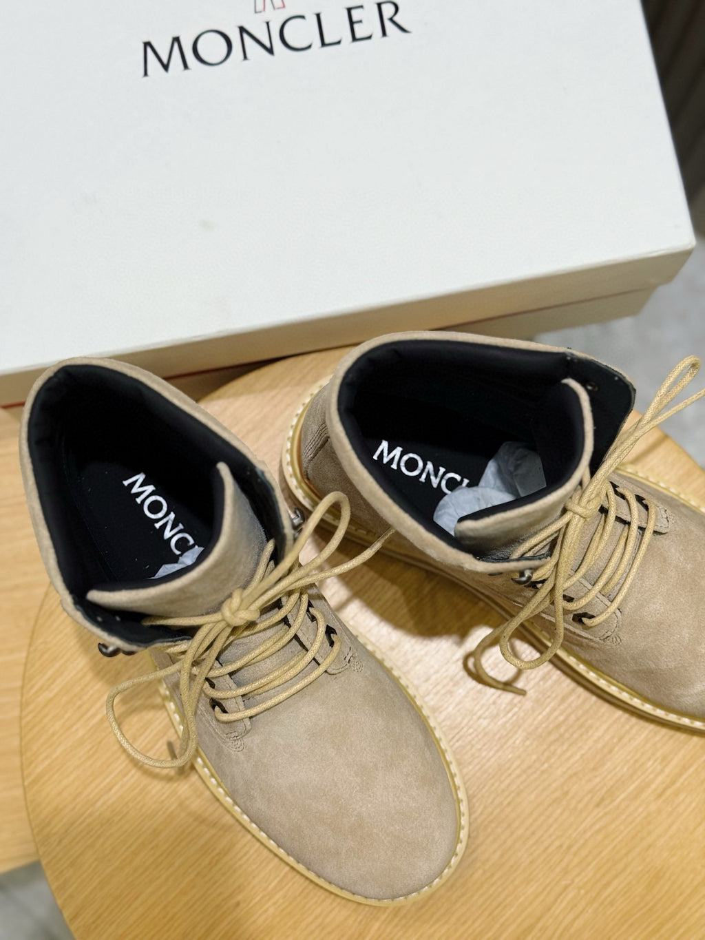 Light beige lace-up ankle boots with Moncler text on black heel lining