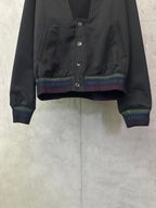 Long-sleeve jacket front, dark button placket with multicolor striped cuffs and hem
