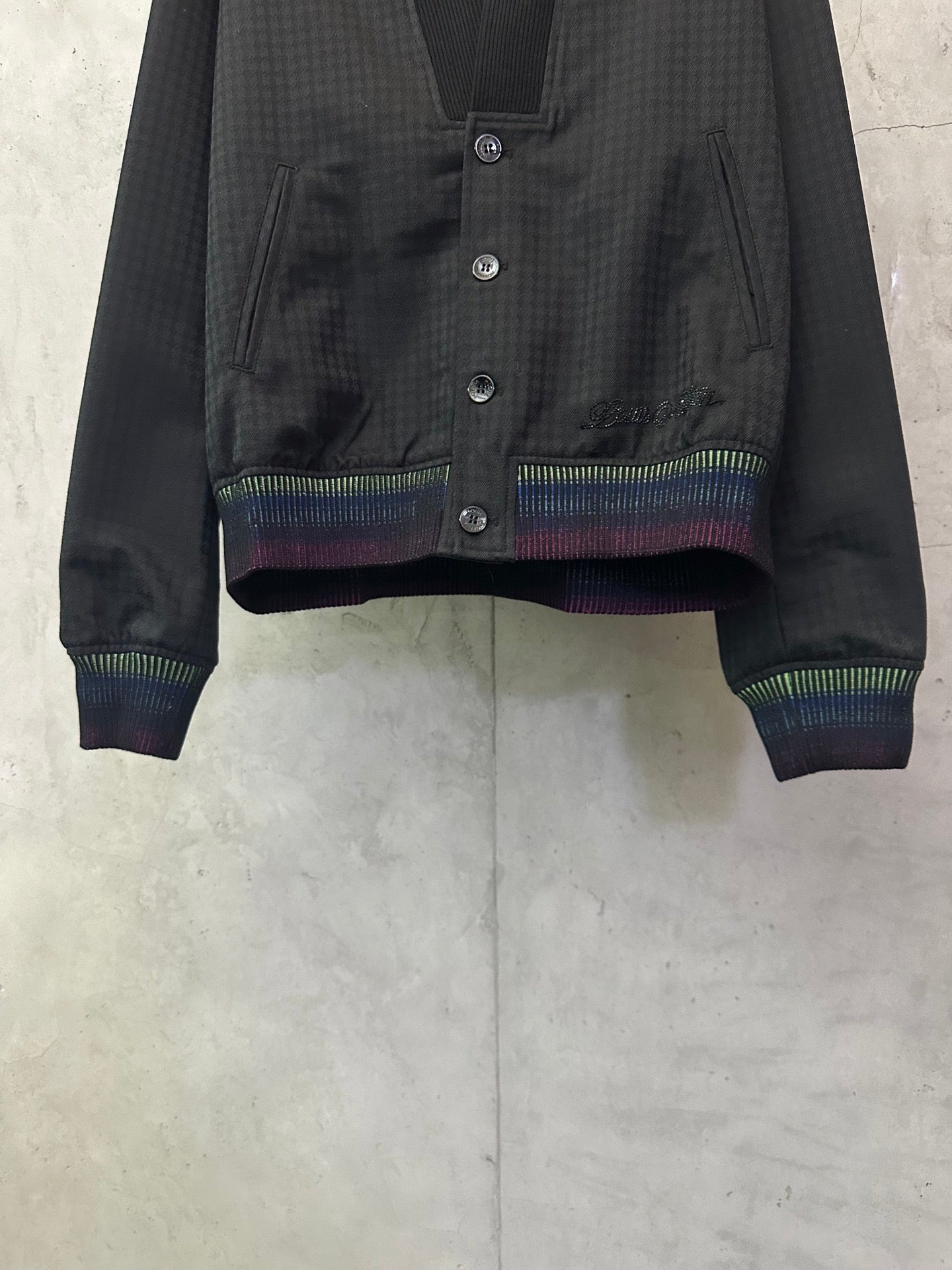 Long-sleeve jacket front, dark button placket with multicolor striped cuffs and hem