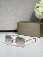 Sunglasses with light pink lenses and rose-gold frame, gold-tone bridge details.