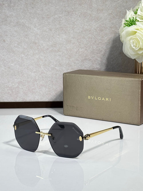 Sunglasses with dark gray lenses and black acetate frame, gold-tone arms and bridge.