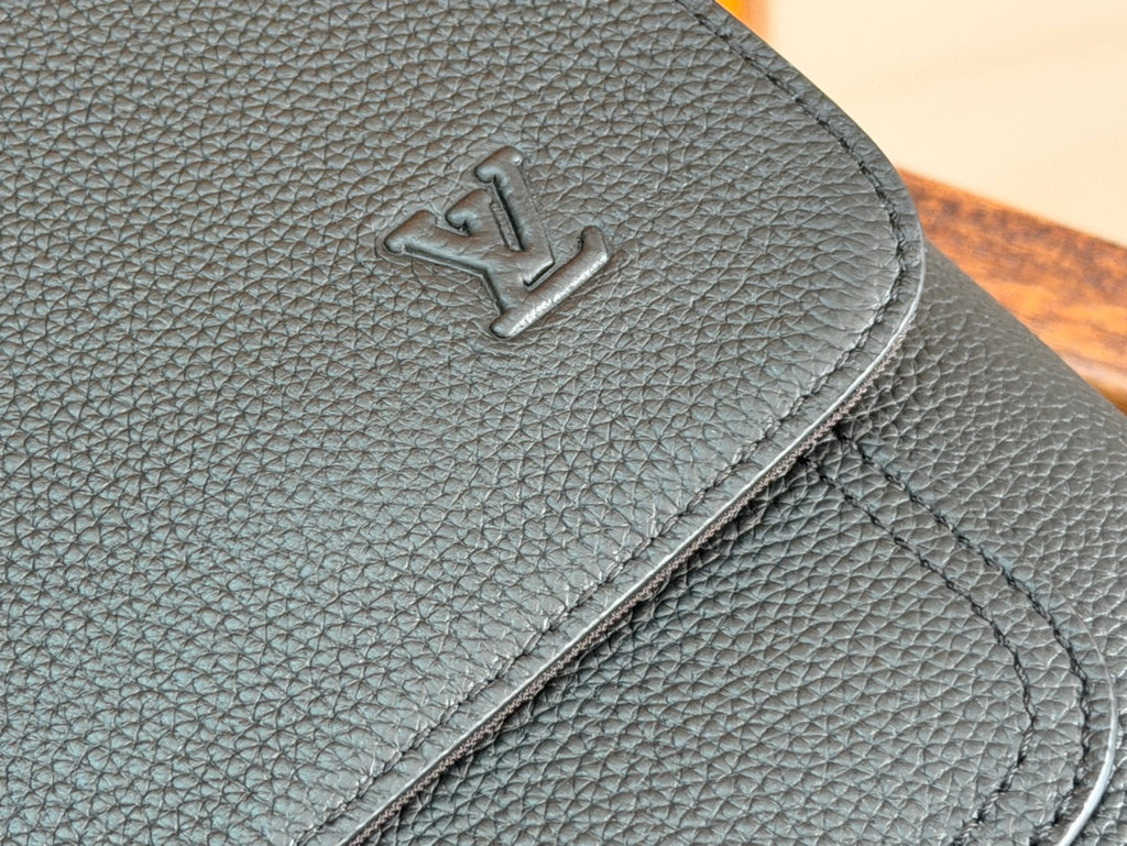 Men's Louis Vuitton leather shoulder bag detail with embossed LV monogram on flap