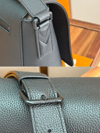 Men's Louis Vuitton shoulder bag closeup with adjustable strap and front badge
